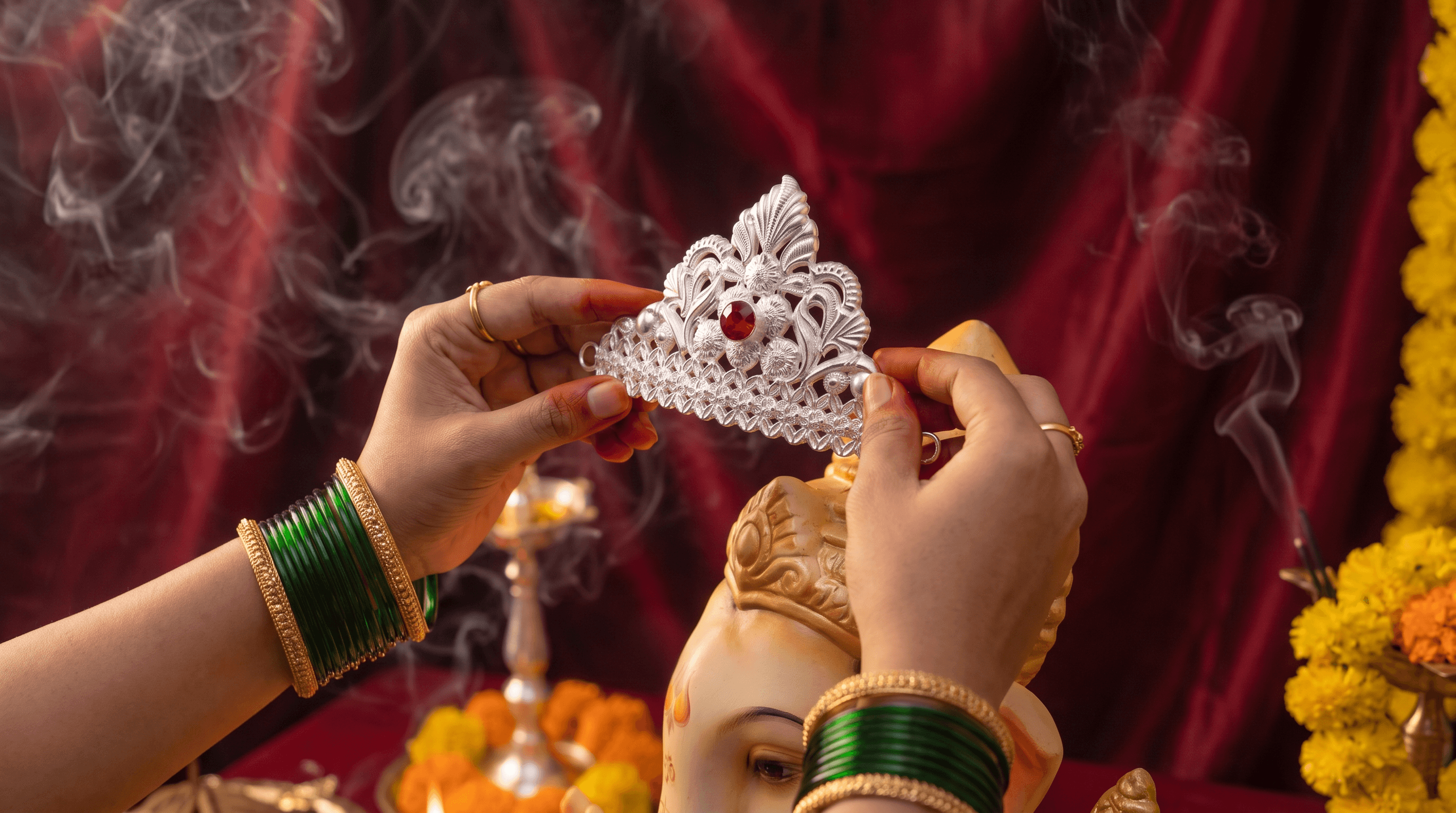 Goldsmith hand-finishing silver puja items